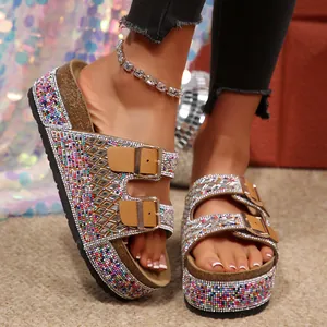 Close-up of women's rhinestone double buckle platform sandals with colorful bead decorations