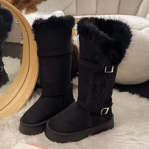 Detail view of stylish black winter snow boots with thick faux fur lining and buckle straps