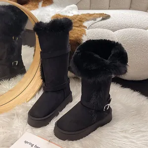 Macro detail view of black snow boots with plush faux fur trim and buckle straps.