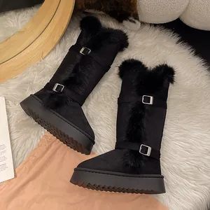 Detailed view of black tall snow boots with faux fur trim and stylish double buckle straps.
