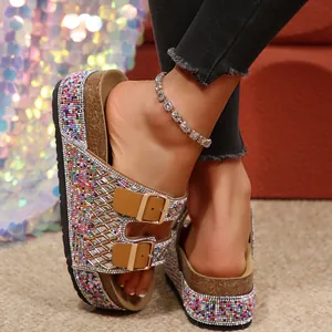 Detailed macro view of women's sparkling rhinestone cork platform sandals with gold double buckles