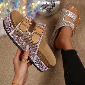 Detailed macro view showing colorful rhinestones and mirror accents on cork sandals