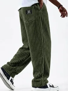 Detail view of men's wide-leg corduroy pants in olive green with ribbed texture