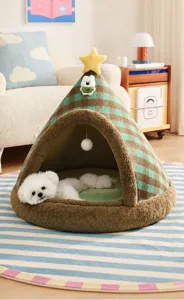 White puppy sleeping inside a cozy green plaid conical pet tent bed in a living room