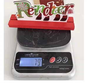 Detail showing the 79g weight of the festive Reindeer Christmas wooden desktop sign