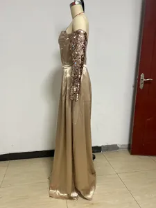 Side view of an elegant one-shoulder champagne sequin evening gown on a mannequin