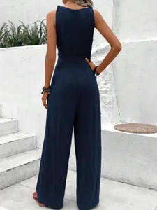 Rear view of an elegant navy blue sleeveless wide-leg jumpsuit with textured fabric