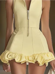 Detail view of pale yellow zip-front sleeveless mini dress with a feminine ruffled hem.