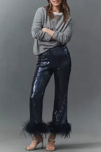 Detail showing texture of navy blue sequins and decorative feather trim on the pant cuffs