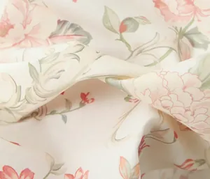 Detailed view of the soft floral print fabric with pink flowers and green leaves
