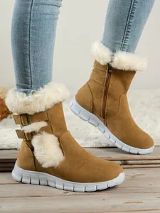 Women's brown snow boots with white faux fur trim and thick soles shown on a white rug