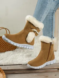 Side detail view of brown women's snow boots with white faux fur trim and buckle straps