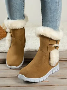 Detail view of tan snow boots with white faux fur trim and stylish buckle straps.
