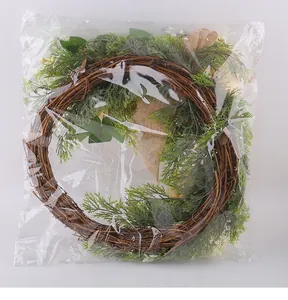 Autumn harvest festival wreath with green foliage shown in clear plastic packaging