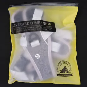 Detail view of the gray reflective dog harness vest inside its frosted zip-lock packaging bag