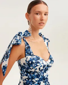Floral print evening dress with elegant bow shoulder straps shown on a studio model
