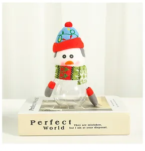 Detailed view of a snowman-themed transparent candy jar with a knit hat and scarf