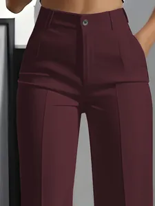 Close-up of burgundy high-waisted straight trousers featuring button detail and pockets