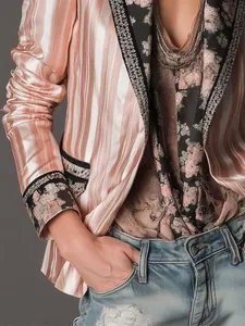 Detailed view of pink striped bohemian blazer featuring floral embroidery lapels