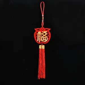 Detail view of a traditional red felt Chinese New Year hanging ornament with gold Fu character