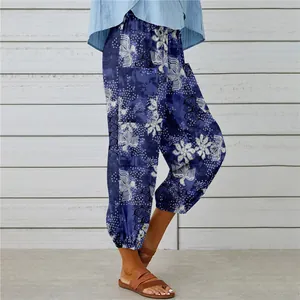 Detail view of vintage blue floral crane print cotton linen pants with elastic cuffs.