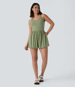 Sleeveless sage green romper featuring a gathered waist and practical side pockets details