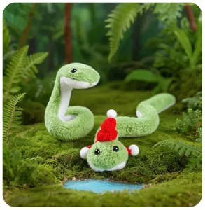 Gros plan de mignonnes peluches serpents verts dans une forêt de mousse miniature
