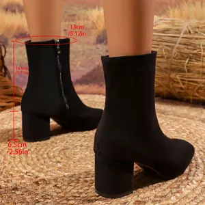 Detail view of black chunky heel boots with dimensions in centimeters and inches.