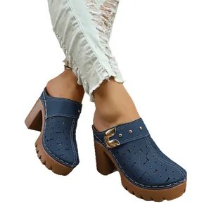 Stylish women's navy blue platform clogs with floral cutout design and chunky heels