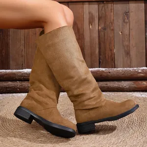 Side view of brown slouchy suede Western cowboy boots for women with comfy flat heels