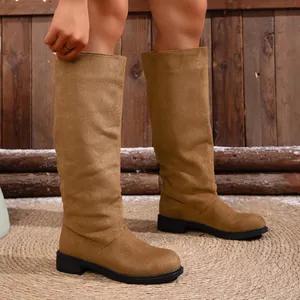 Detailed view of camel suede knee high boots with a stylish slouchy shaft for women.