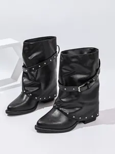 Detailansicht schwarze slouchy Stiefeletten mit silbernen Nieten und Schnallenriemen.