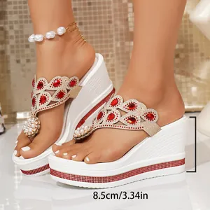 Close-up of white platform wedge sandals with red rhinestones and 8.5cm heel height detail