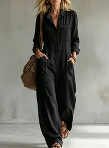 Detail of a black linen jumpsuit featuring button-down front and wide-leg design