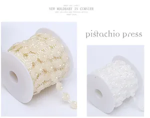 Detailed view of 15mm ABS lotus beaded chains in white and cream colors for DIY craft projects