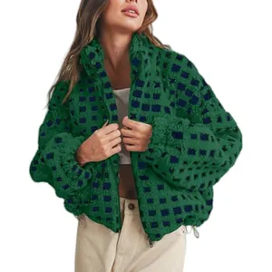 Close-up detail of the green and navy checkered sherpa fleece jacket on a model