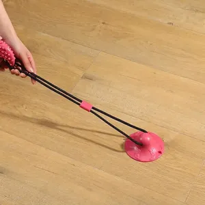 Durable suction cup dog chew toy with rope for interactive tug-of-war on floor.
