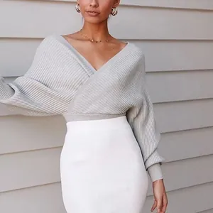 Detail view of grey knit crossover V-neck sweater with batwing sleeves texture