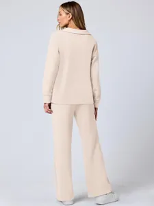 Back view of a women's beige long-sleeve loungewear set with wide-leg trousers for autumn.