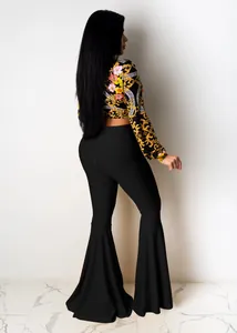 Sexy two-piece set featuring floral baroque crop top and black ruffle flared pants