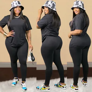 Detailed view of women's two-piece black clubwear set including casual T-shirt and leggings