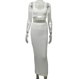 Detailed view of a white knit two-piece set featuring a crop top and bodycon maxi skirt