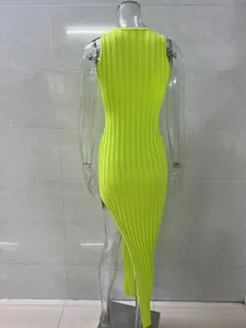 Back view of neon yellow ribbed knit bodycon dress with high asymmetrical side slit.