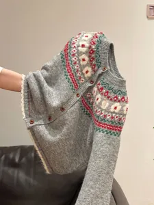 Close-up view of a soft grey Fair Isle patterned knit cardigan with vintage buttons.