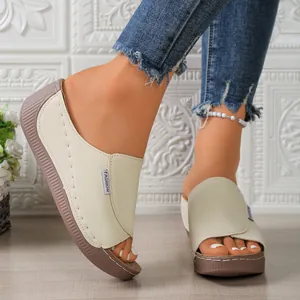 Macro shot showing the side profile and texture of women's peep-toe platform wedge sandals.