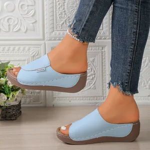 Detail view of light blue wedge platform sandals with open toe design and FASHION tag