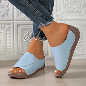Light blue peep-toe wedge platform slides with fashion tag for stylish casual wear.