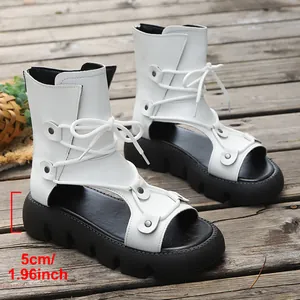 Nahaufnahme weißer Schnür-Plateau-Sandalen im Römerstil mit einem 5 cm hohen Absatz.