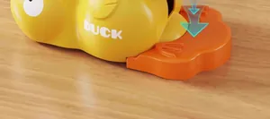 Close-up view of the orange press button on the yellow duck pet treat dispenser toy