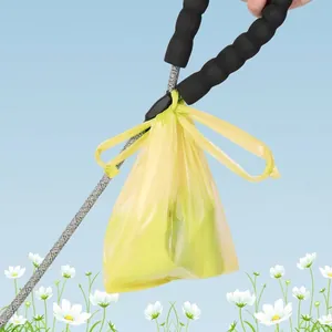 Thickened yellow dog waste bag with easy-knot handles tied to a foam leash handle